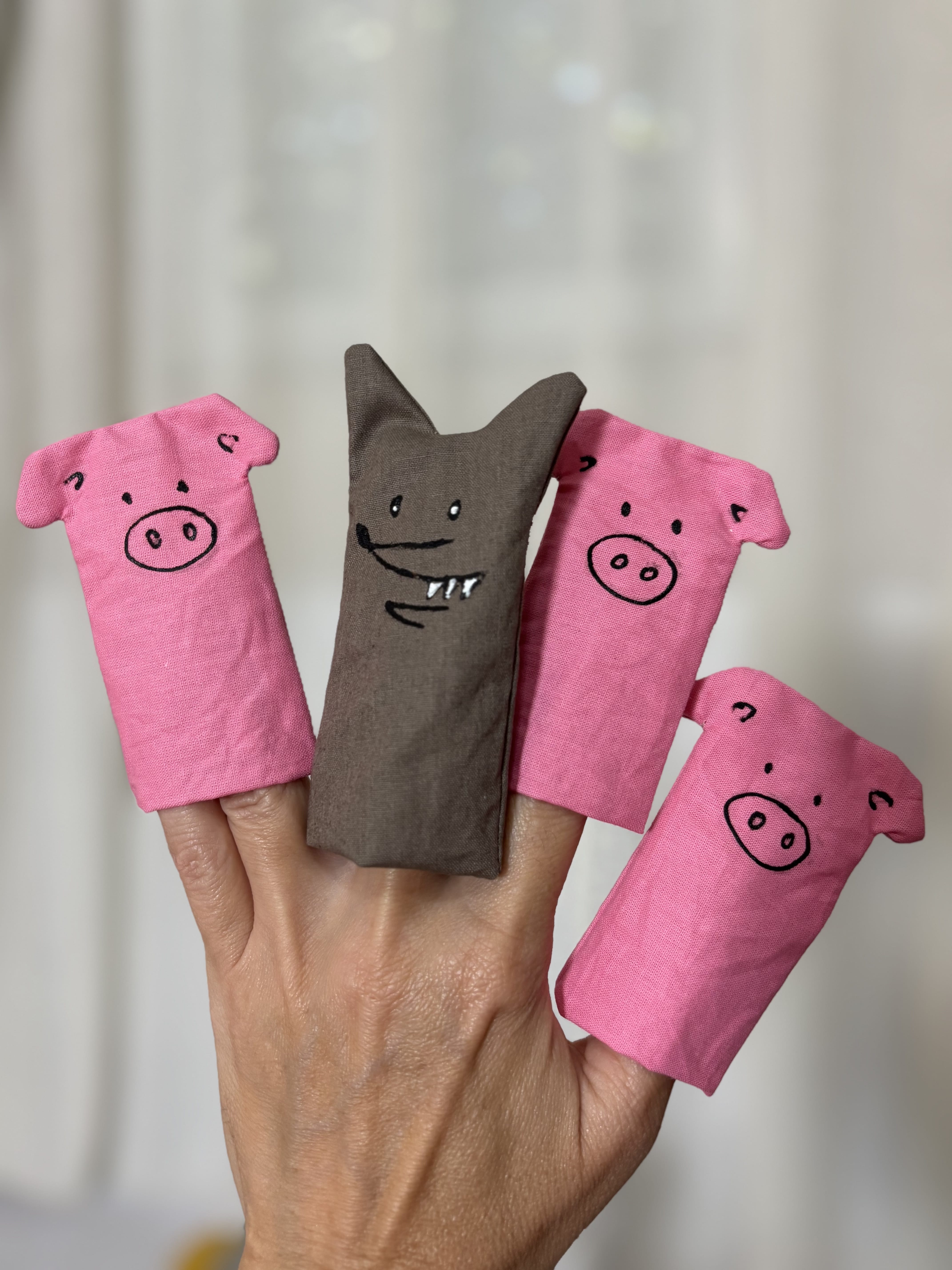 Brick-colored puppet theater with the characters from the fairy tale "The Three Little Pigs"