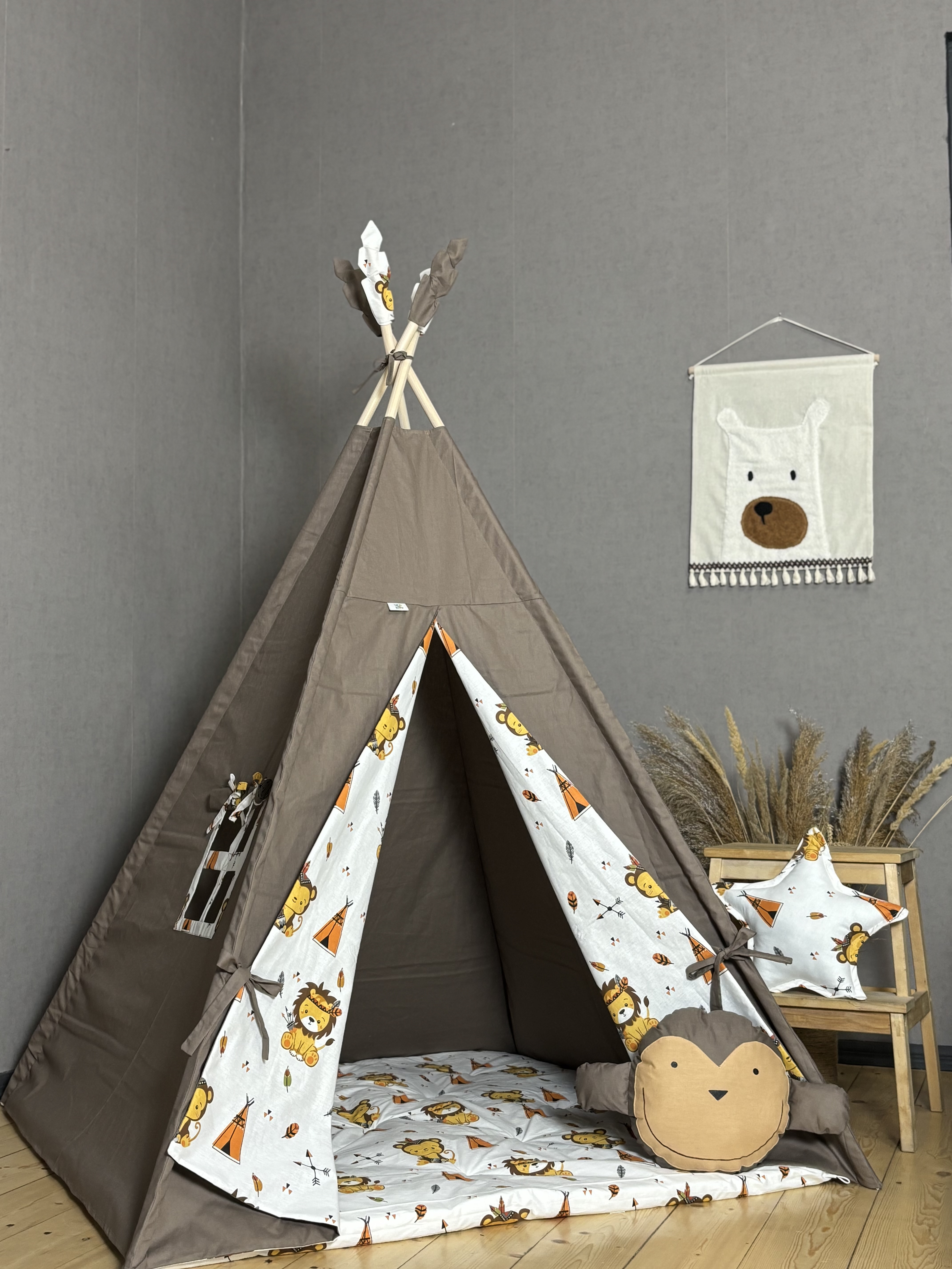 Brown tent with monkey and square shaped pillows