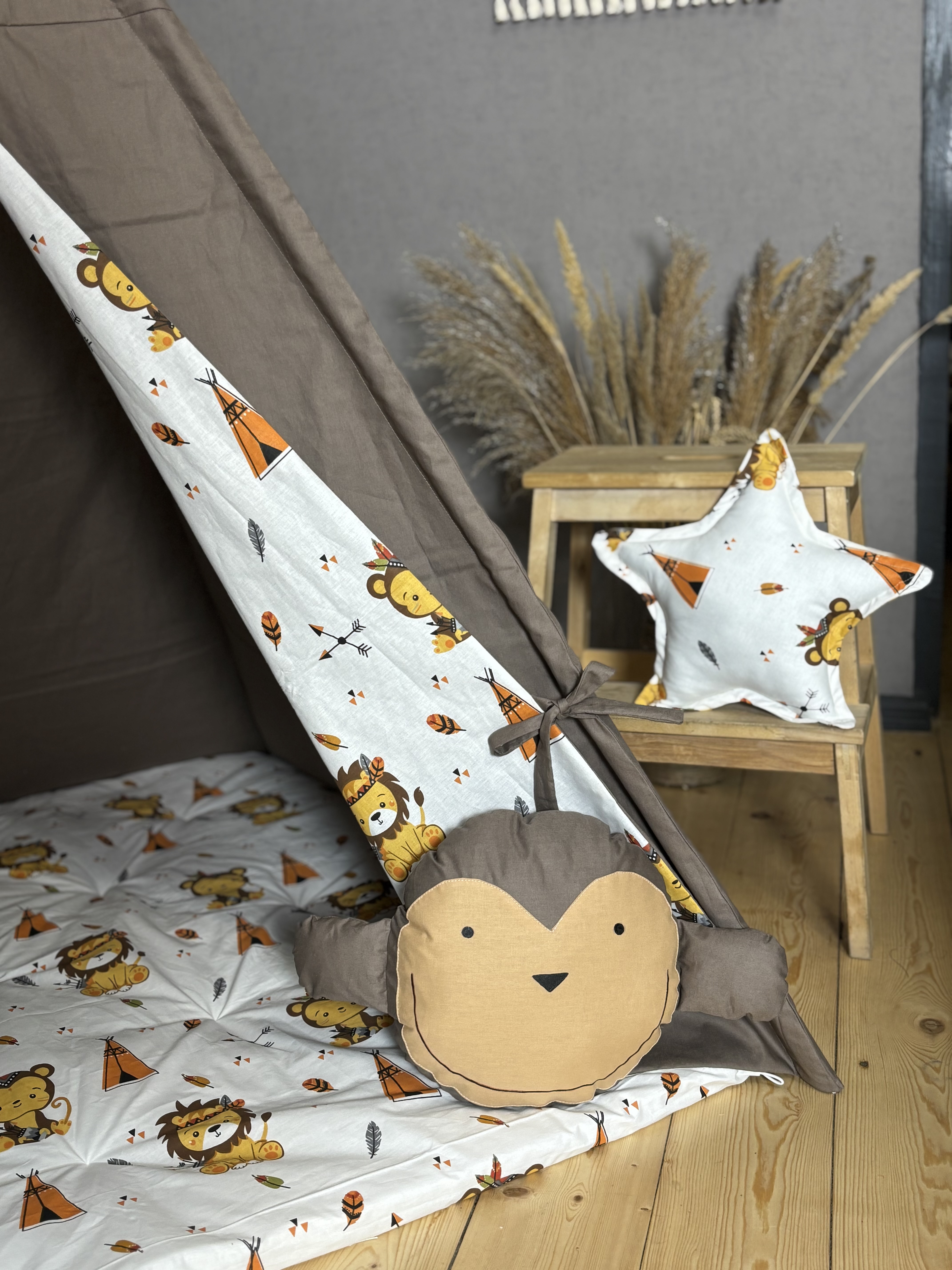 Brown tent with monkey and square shaped pillows