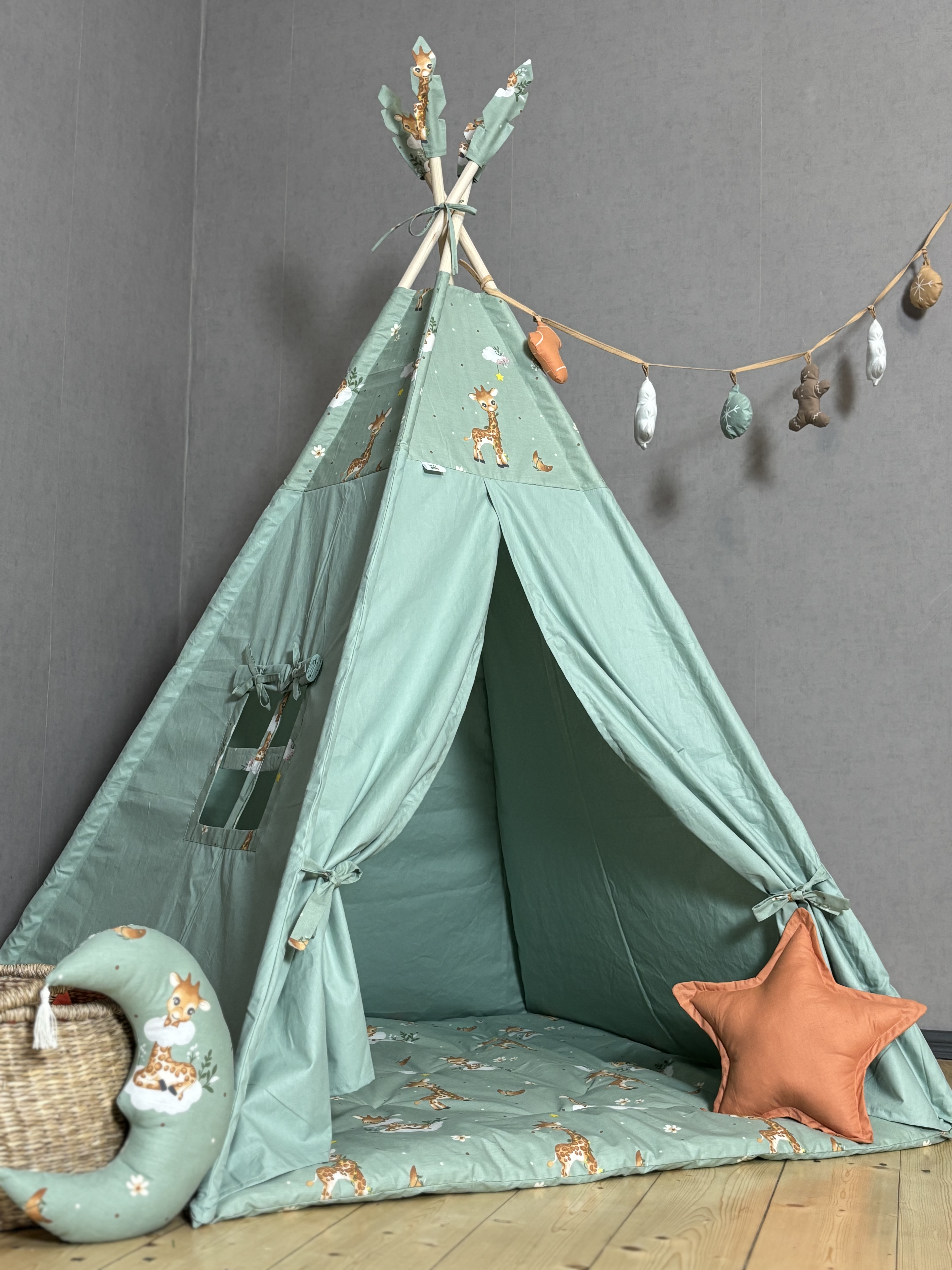 Green tent with giraffe print and garland