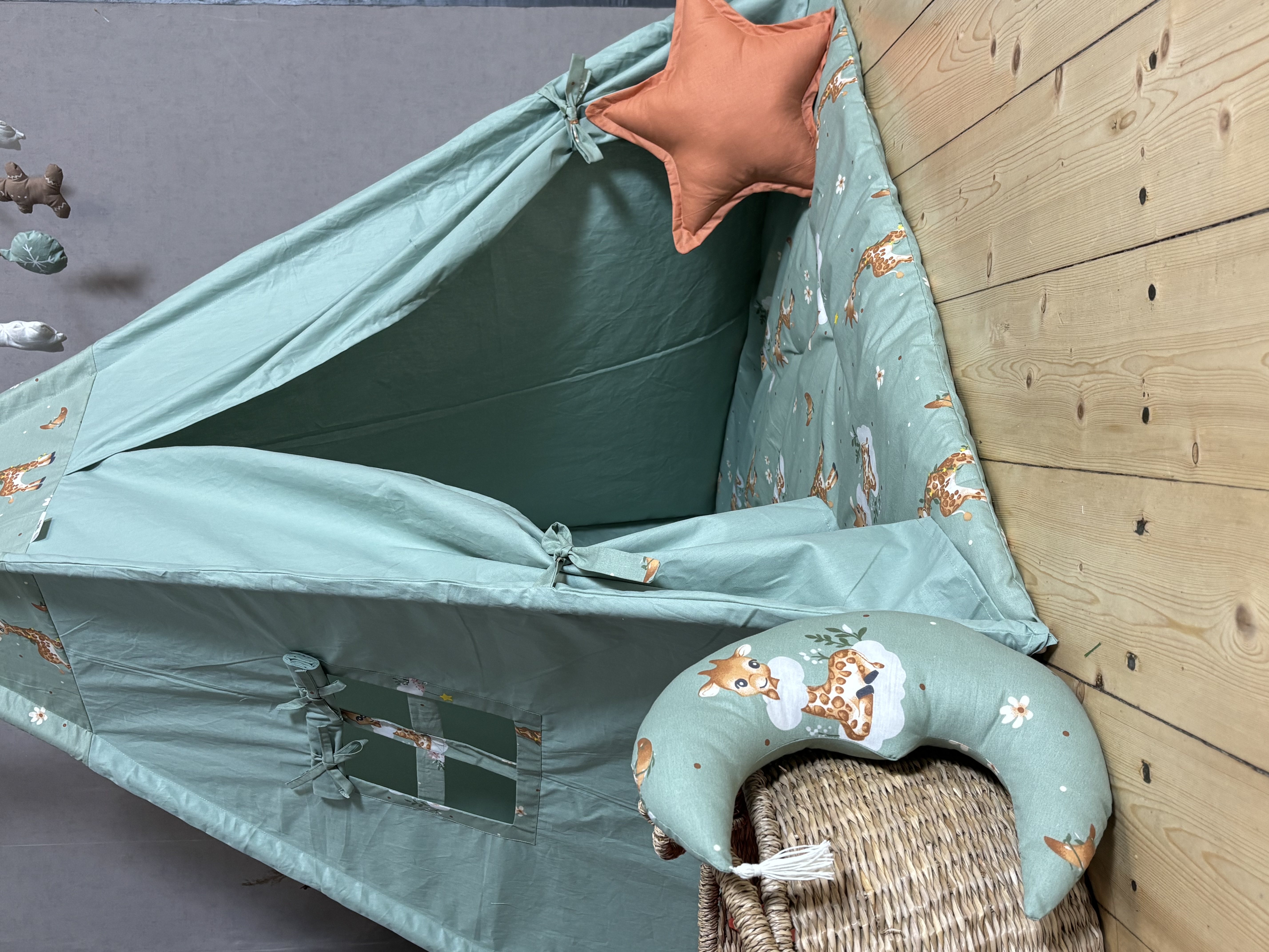 Green tent with giraffe print and garland