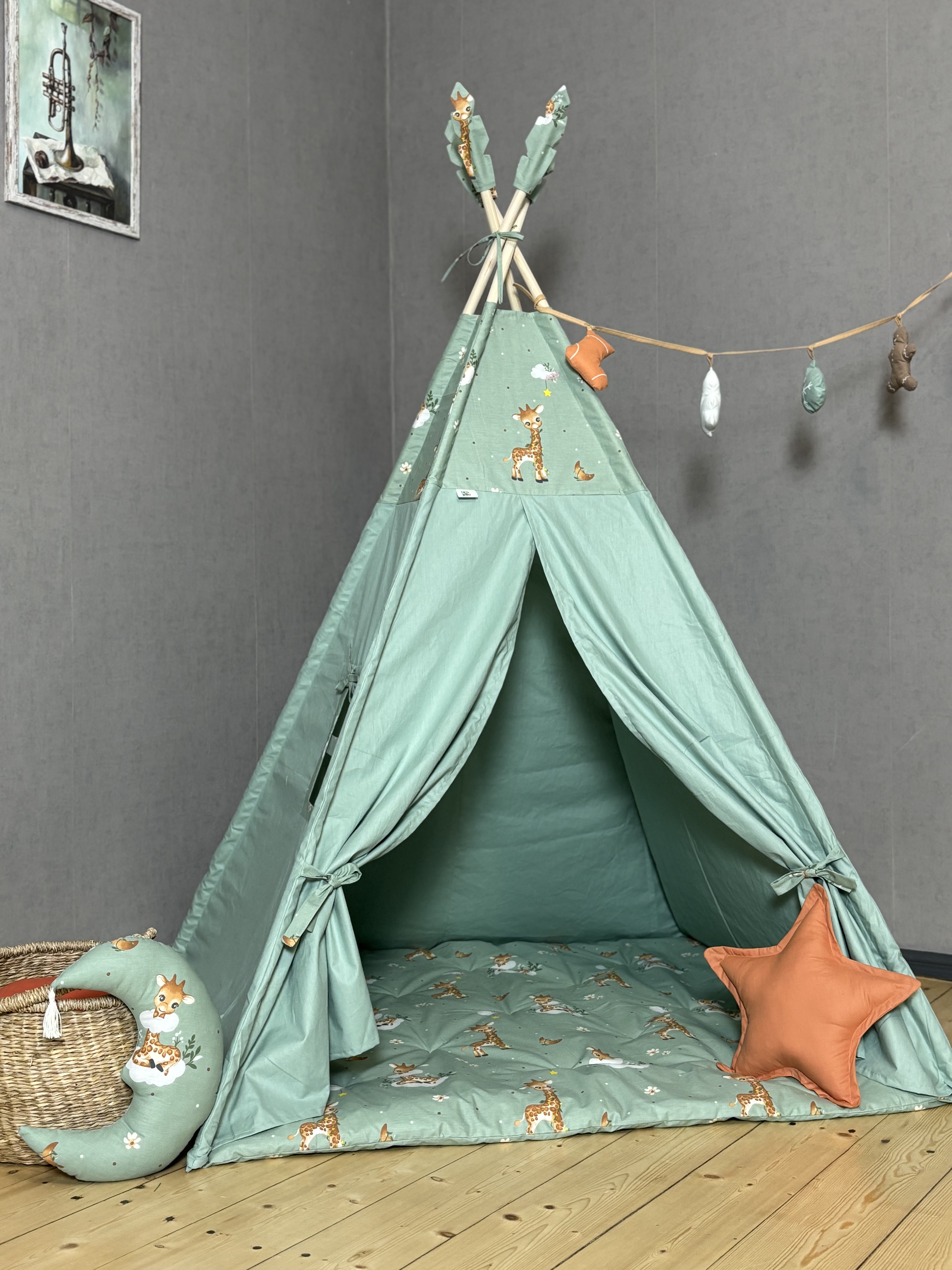 Green tent with giraffe print and garland