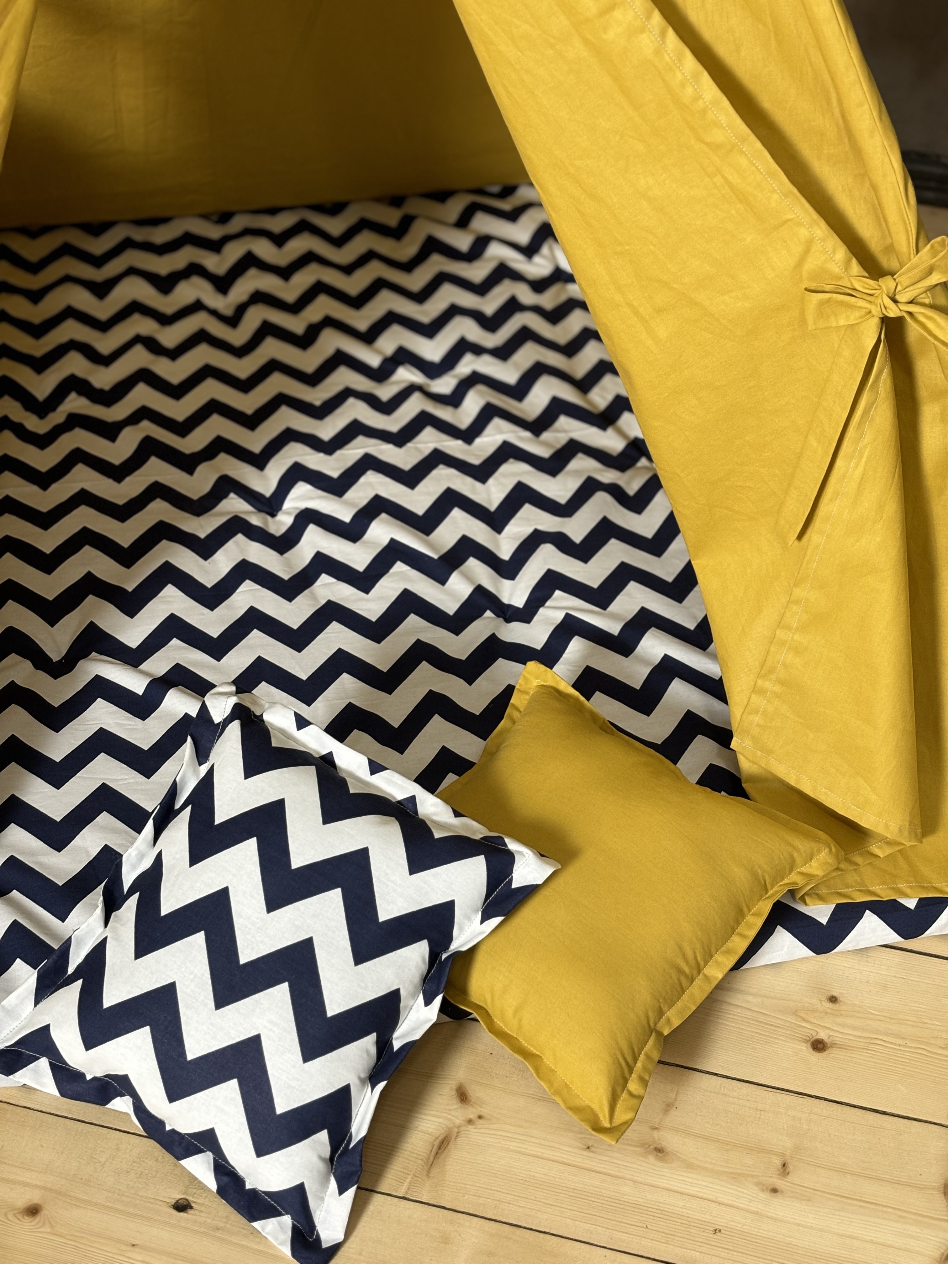 Yellow tent with blue zigzag lining