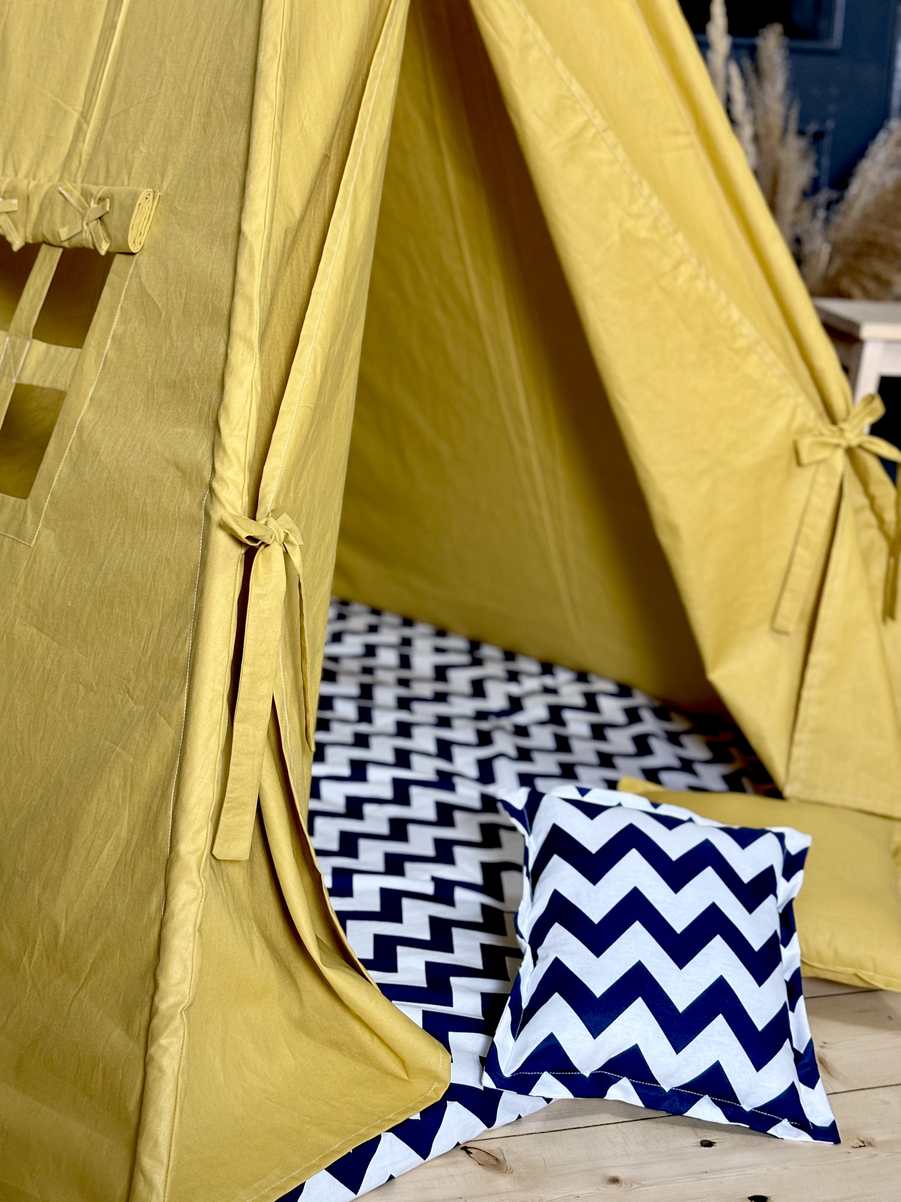 Yellow tent with blue zigzag lining