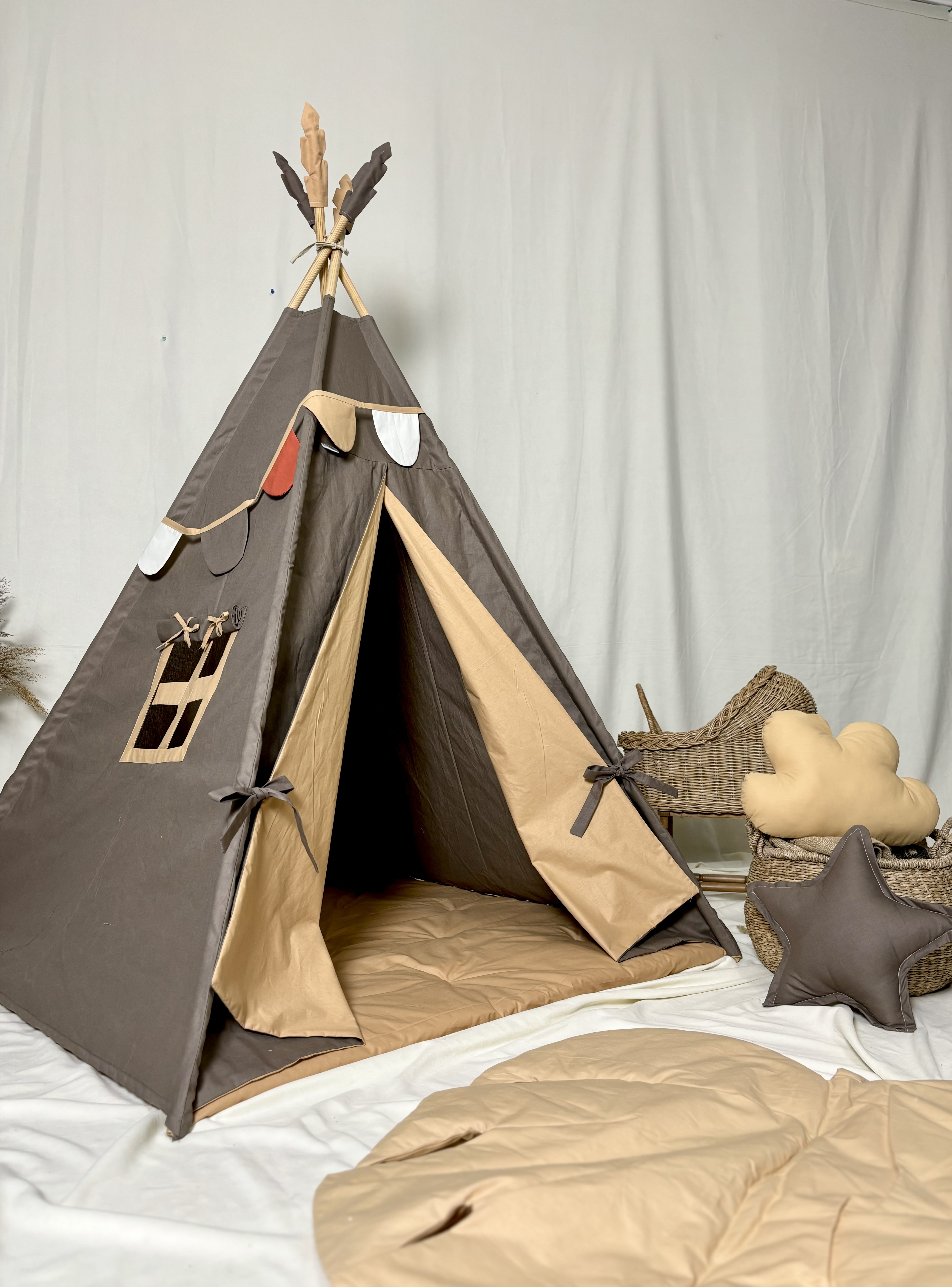 Brown tent with yellow lining and flags