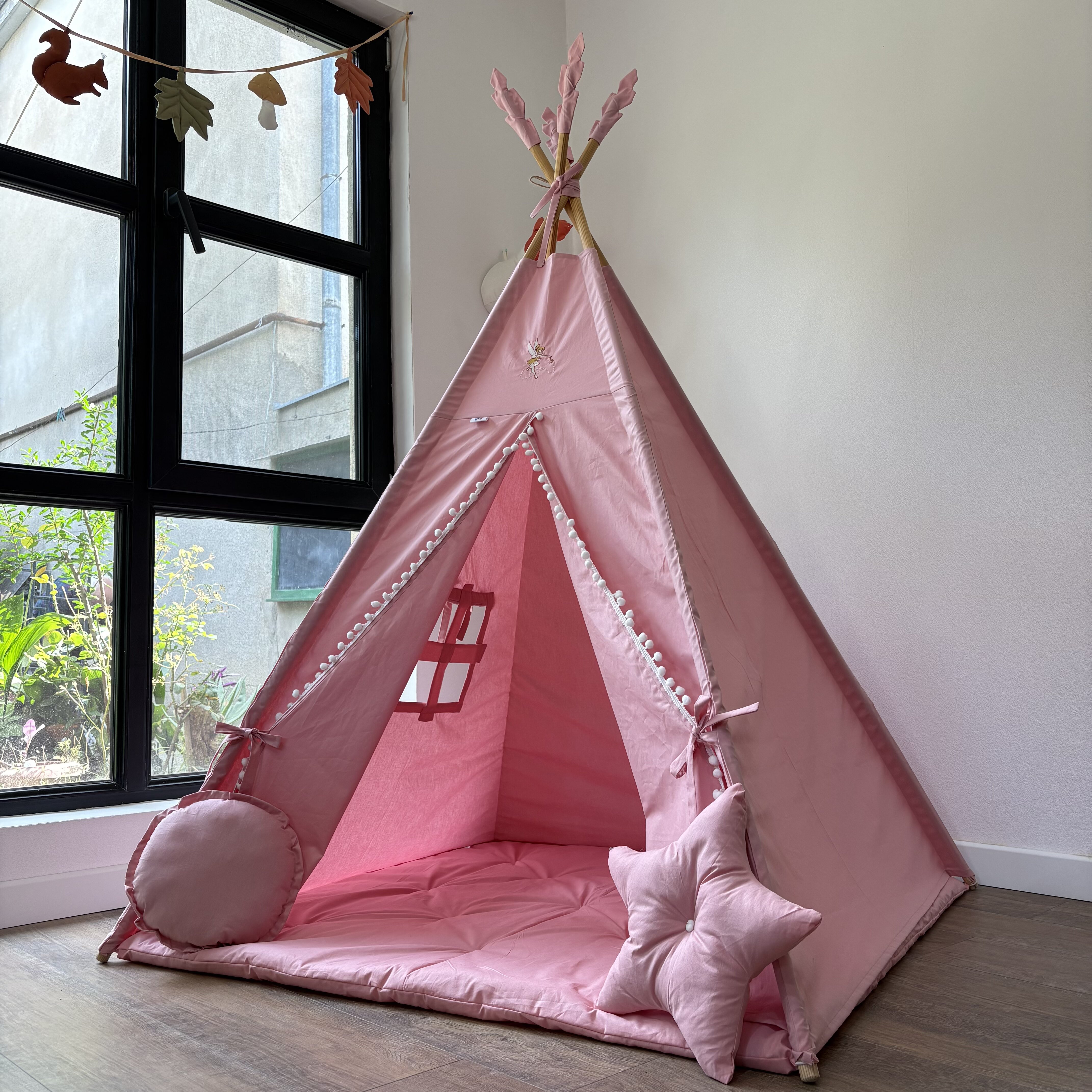 Pink tent with embroidery on the peak