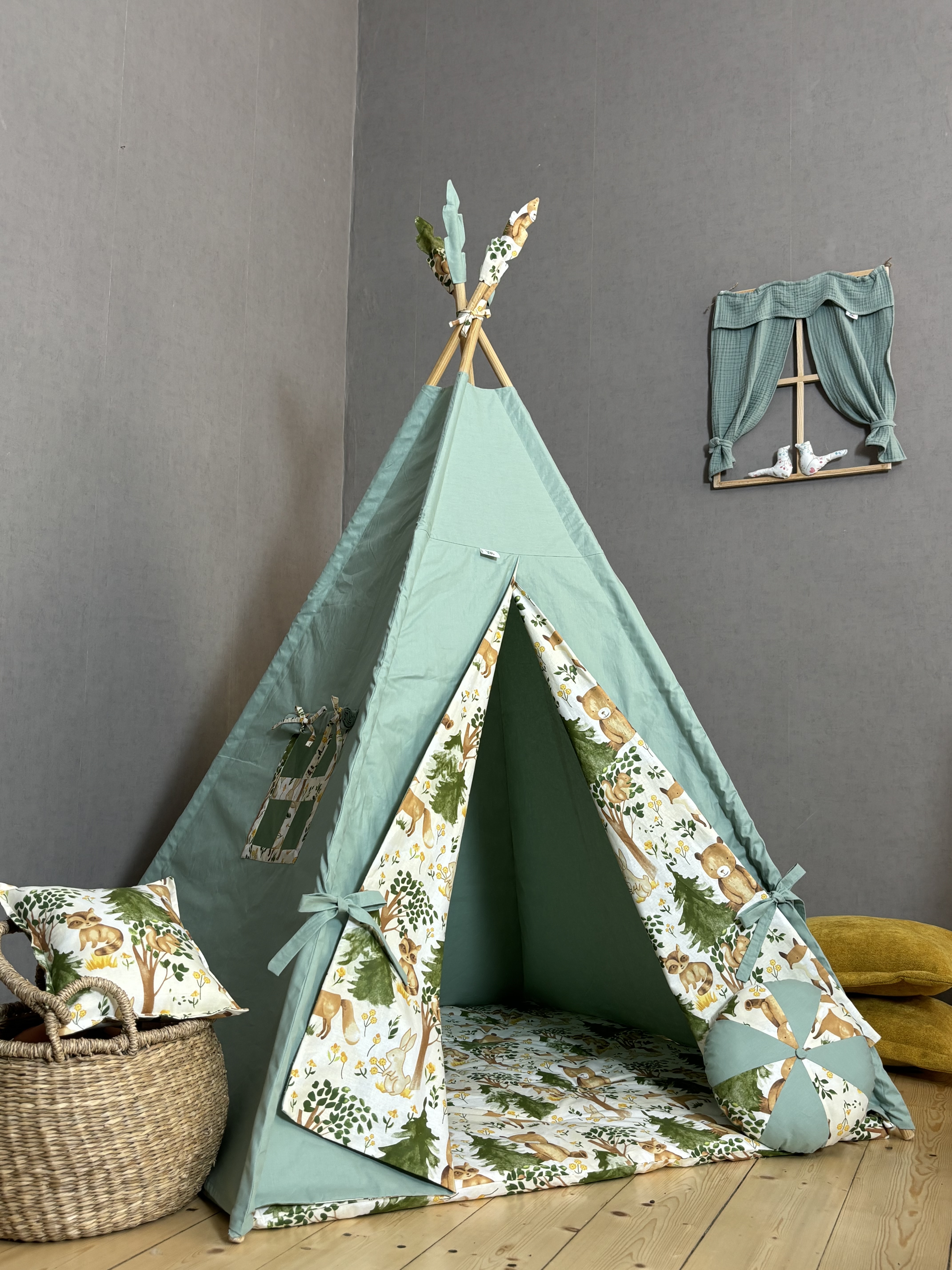 Green tent with animal print, round and square cushions