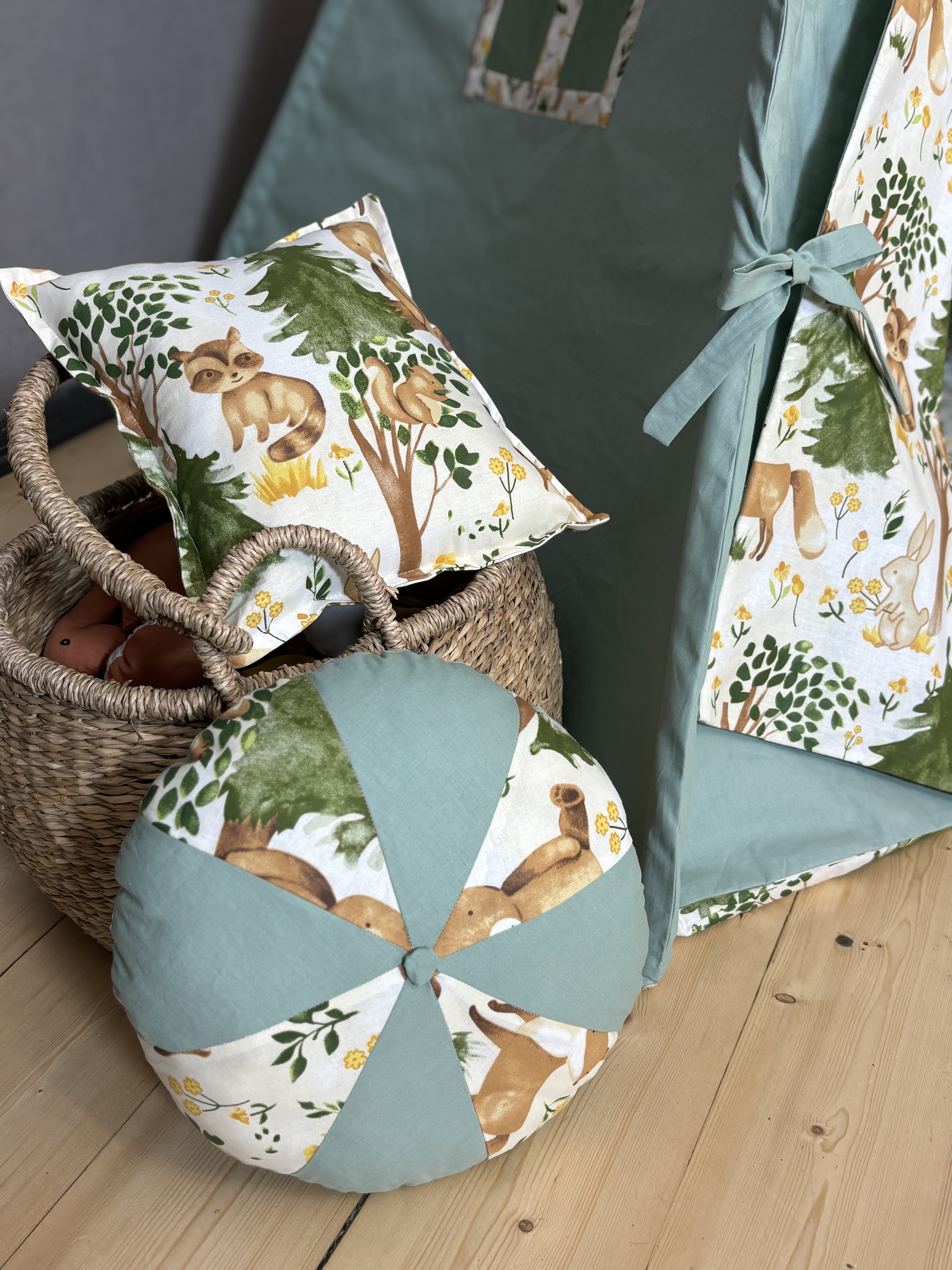 Green tent with animal print, round and square cushions